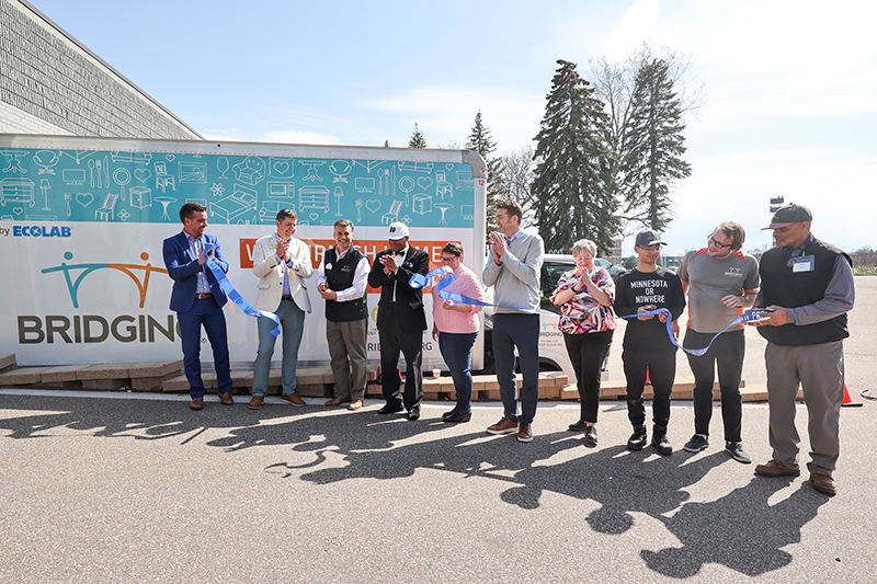 A group of people at a ribbon cutting ceremony